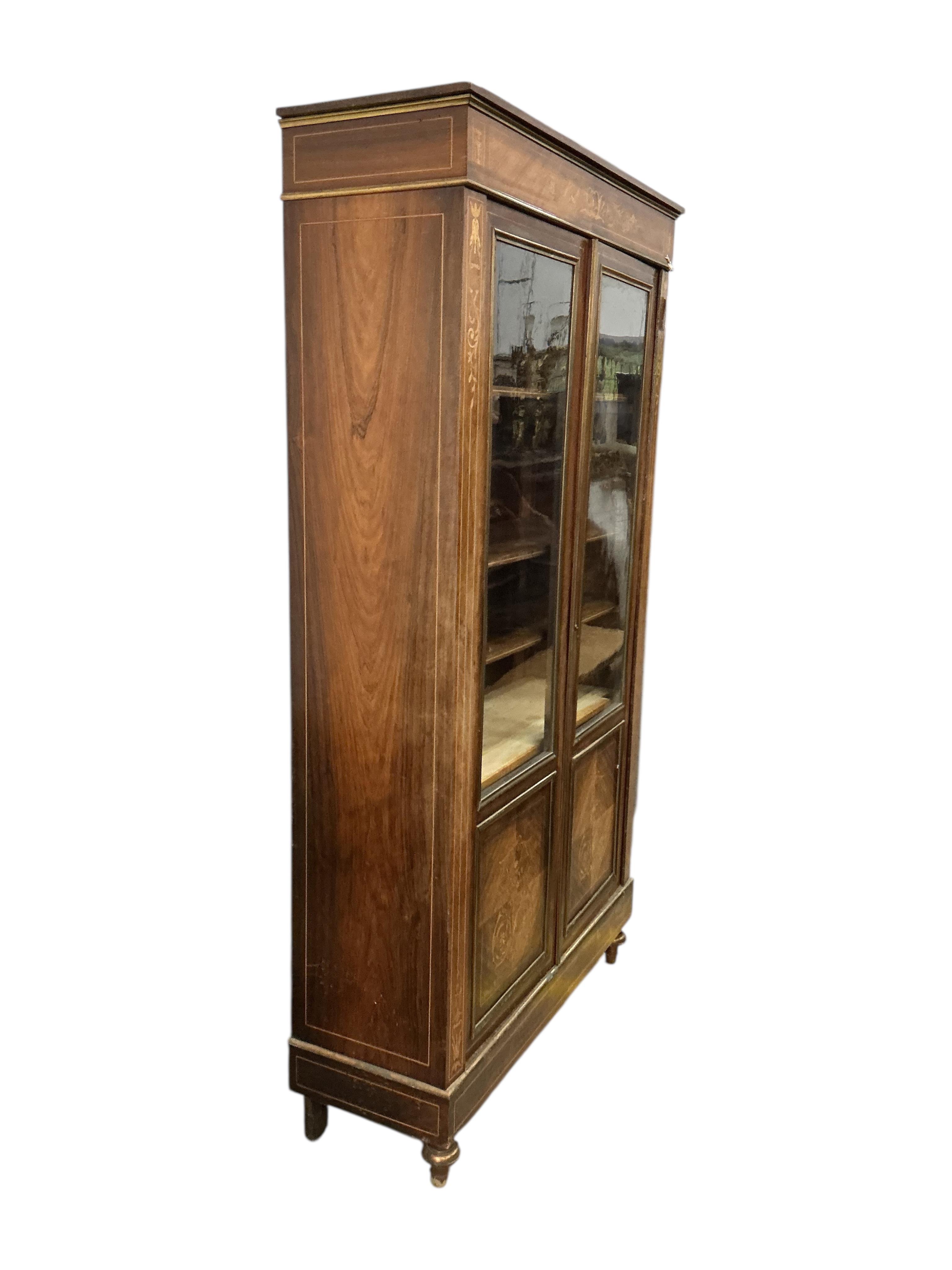 An early 20th century French brass mounted marquetry inlaid rosewood bookcase, width 104cm, depth 35cm, height 187cm